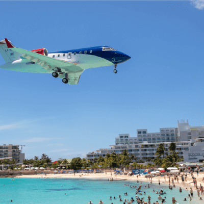 Air ambulance travelling over a beach