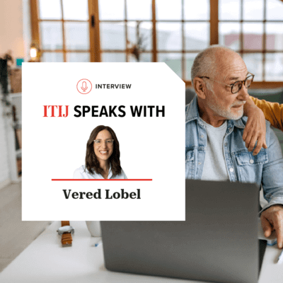 Mature couple looking at laptop with credit card