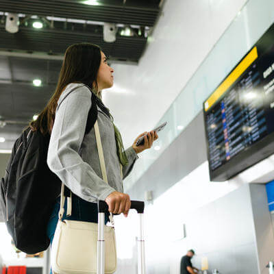 A business traveler looking at the flight board