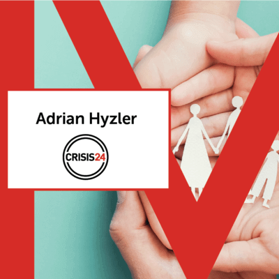 Hand holding a cut out of a family