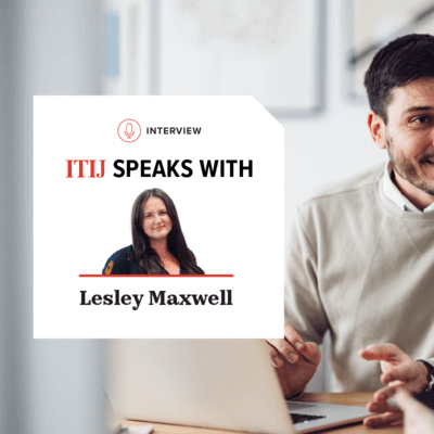 Two people talking together over a laptop