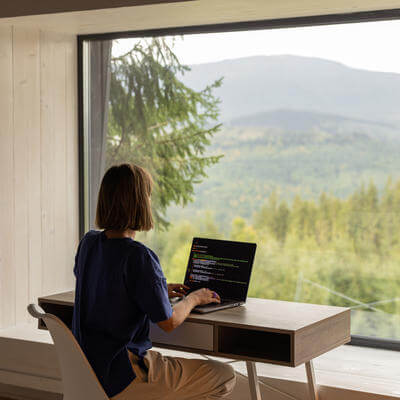 Woman sat at desk with view