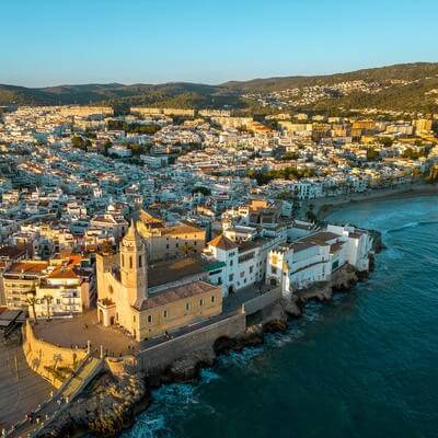 Drone point of view of Sitges City at sunset