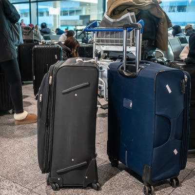 Passengers with luggage waiting at airport