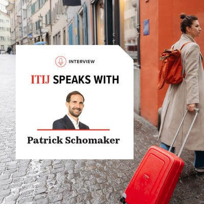 Woman walking cobbled streets with suitcase