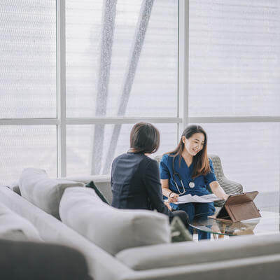 Asian female doctor explaining medical report 