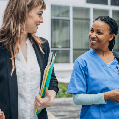 Two hospital workers talking to each other