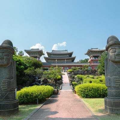 Yakcheonsa Temple and Dol hareubang in Jeju Island, Korea