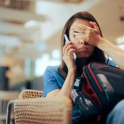 Woman talking on the phone waiting in an airport