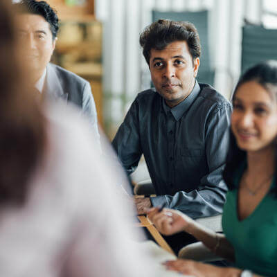 Colleagues Thriving in a Modern Meeting Room as They Work Toward Shared Goals