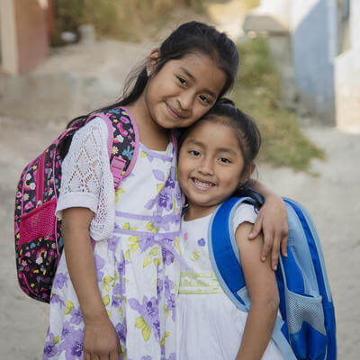 Hispanic girls ready to go to school in rural area