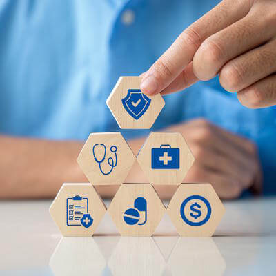 Hand arranging healthcare building blocks 