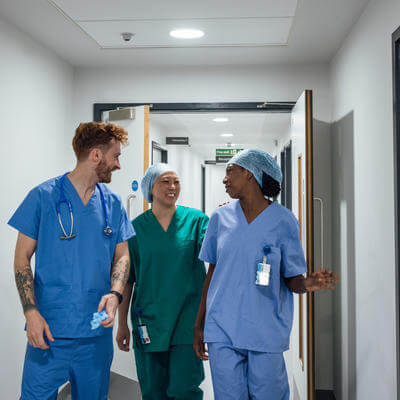 doctors having a conversation in a hospital corridor, wearing their medical scrubs