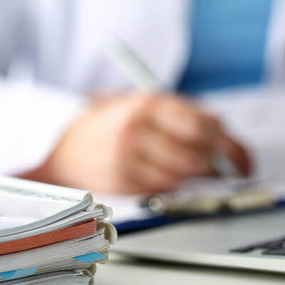 Stethoscope head lying on medical forms closeup