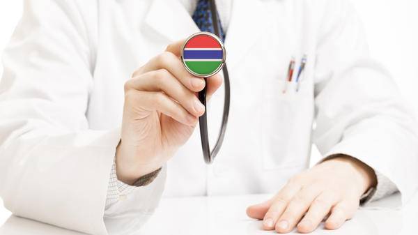 Dr with stethoscope with Gambia flag