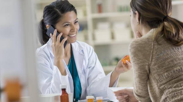 A medical professional talks to a customer's insurance company on the telephone