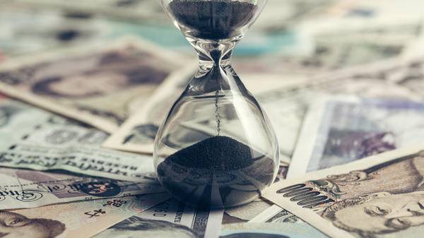 Hourglass on top of money