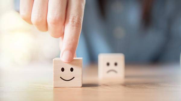 smiley face and blurred sad face icon