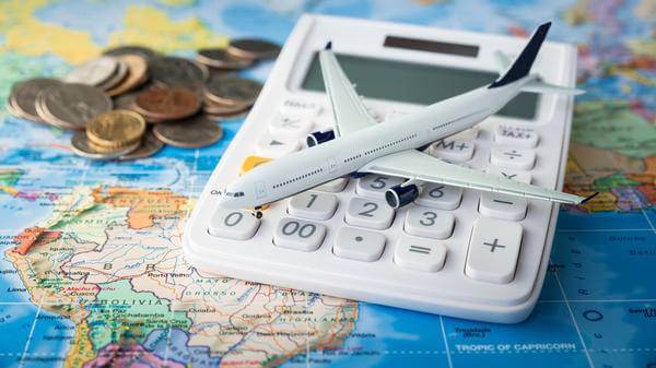 Calculator and toy plane on a map