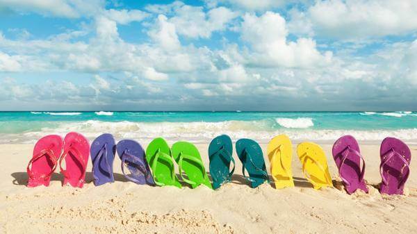 Flip flops lined up on a beach