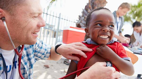 A doctor helping a patient overseas