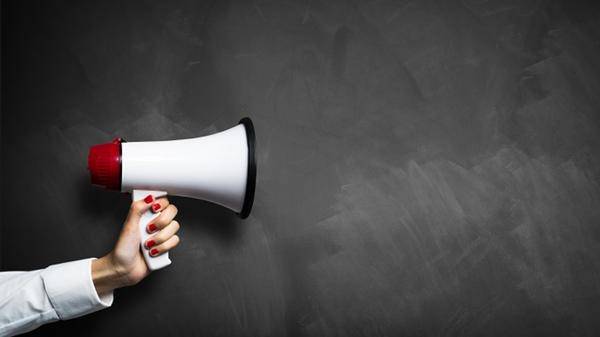 Megaphone in front of a chalkboard