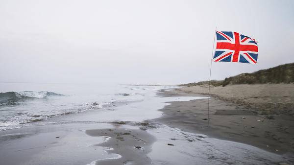 A lone Union Jack on the cold grey beach of Brexit