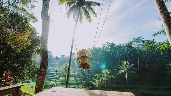 Female traveller on a swing