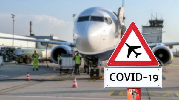 Airplane at the airport warning sign coronavirus