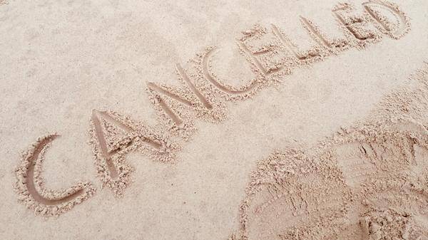 'Cancelled' written on the beach