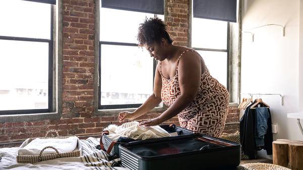Woman packing suitcase