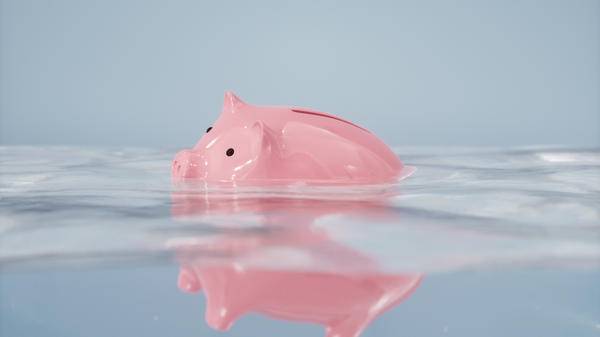 A piggy bank sinking below the water
