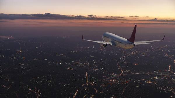 Airplane above city