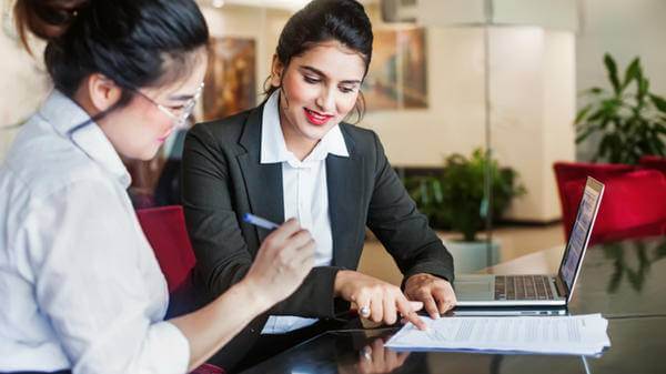 Woman customer signing something at a bank in India