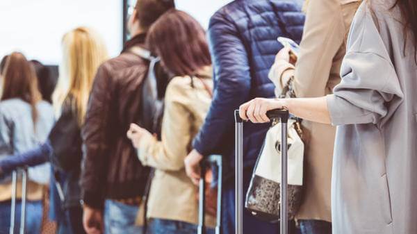 Passengers queue at airport