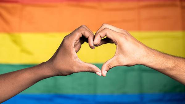Love symbol in front of pride flag