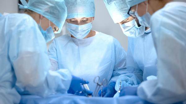 Four medics performing surgery