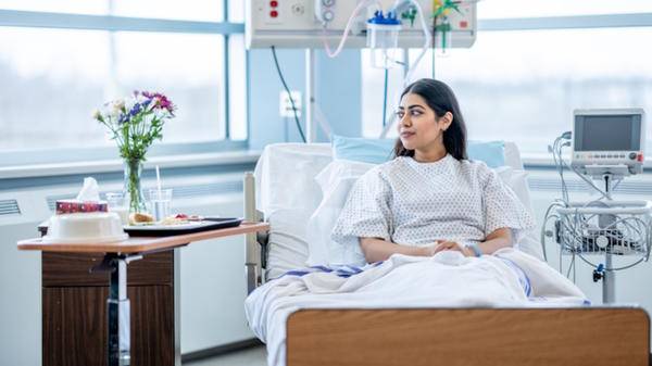 hospital woman in bed with flowers