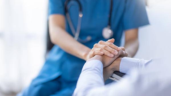 Doctor holding patients hand
