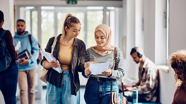 Two students in America walking in corridor