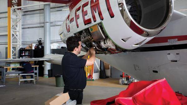 engineer working on air ambulance aircraft engine