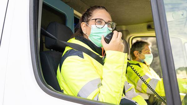 Woman in passenger seat in a safety jacket 