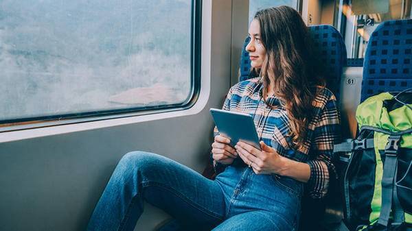 Woman on train with an iPad