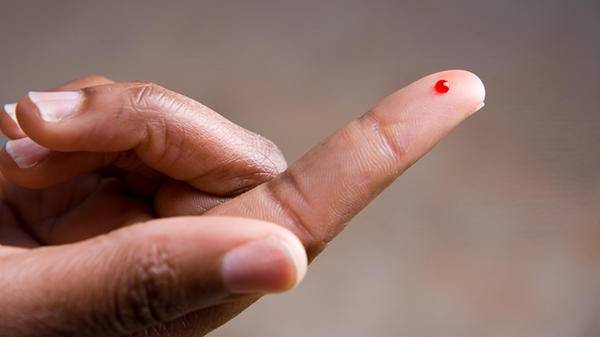 Finger prick blood hand 