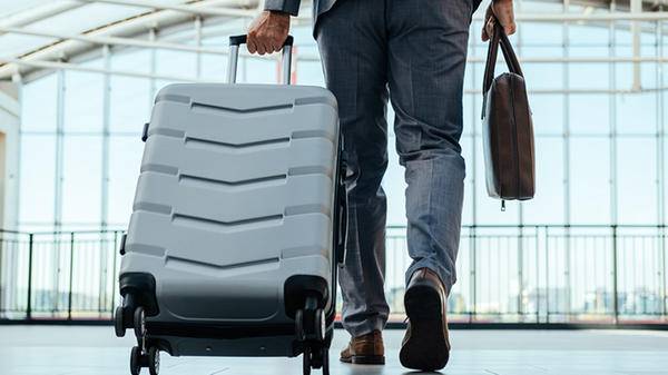 Man pulling suitcase airport