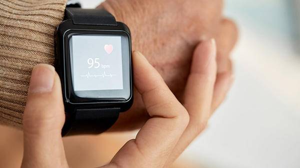 Person using smart watch to check heart rate 