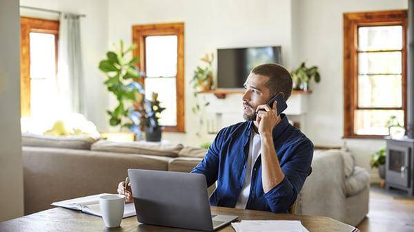 Man talking on the phone in his home