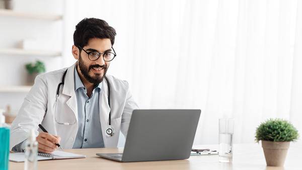 Male doctor using laptop