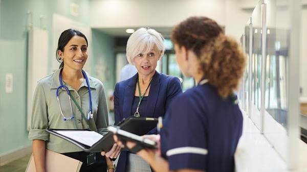 Hospital colleagues talking at reception