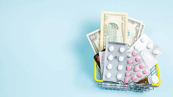 Doctors pills and money in a miniature basket 